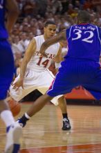 UT junior A.J. Abrams (#3, G) playing defense against a Kansas player.  The University of Texas (UT) Longhorns defeated the University of Kansas Jayhawks 72-69 in Austin, Texas on Monday, February 11, 2008.

Filename: SRM_20080211_2153181.jpg
Aperture: f/2.8
Shutter Speed: 1/640
Body: Canon EOS-1D Mark II
Lens: Canon EF 80-200mm f/2.8 L