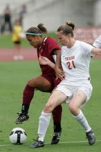 UT senior Stephanie Logterman (#10, Defender) and UT junior Emily Anderson (#21, Forward) team up on Iowa State #16.  The University of Texas women's soccer team won 2-1 against the Iowa State Cyclones Sunday afternoon, October 5, 2008.

Filename: SRM_20081005_12052265.jpg
Aperture: f/5.6
Shutter Speed: 1/1250
Body: Canon EOS-1D Mark II
Lens: Canon EF 300mm f/2.8 L IS