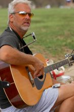 Woode Wood playing his acoustic guitar at Town Lake Hike & Bike trail in Austin, TX.

Filename: SRM_20060312_094302_8.jpg
Aperture: f/4.0
Shutter Speed: 1/800
Body: Canon EOS 20D
Lens: Canon EF 80-200mm f/2.8 L