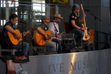 The Gene Pool, performing at the Austin airport.  Geno Stroia II on vocals/guitar, Jorge Castillo on vocals/guitar, Travis Woodard on drums and Steven Ray Will on vocals/bass guitar.

Filename: SRM_20060518_160104_1.jpg
Aperture: f/3.2
Shutter Speed: 1/250
Body: Canon EOS 20D
Lens: Canon EF 80-200mm f/2.8 L