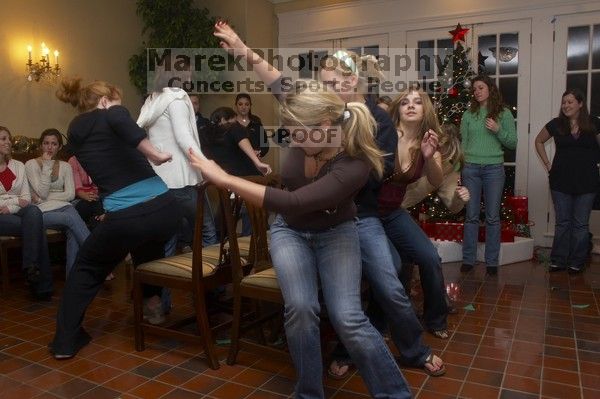 Lindsay Fraley, center, Kaitlen Heeren, and Emily Skipper (in maroon) playing musical chairs at the Alpha Delta Pi Christmas party, Sunday, December 10, 2006.

Filename: SRM_20061210_1813323.jpg
Aperture: f/7.1
Shutter Speed: 1/30
Body: Canon EOS 20D
Lens: Canon EF-S 18-55mm f/3.5-5.6