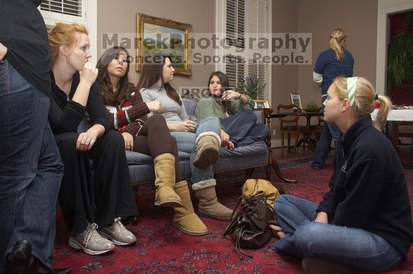 Brittany Hibbs, [name removed], Rachel Hernandez, Cara Scott, and  Kaitlen Heeren (from left) having a discussion at the Alpha Delta Pi Christmas party, Sunday, December 10, 2006.

Filename: SRM_20061210_1829560.jpg
Aperture: f/5.0
Shutter Speed: 1/100
Body: Canon EOS 20D
Lens: Canon EF-S 18-55mm f/3.5-5.6