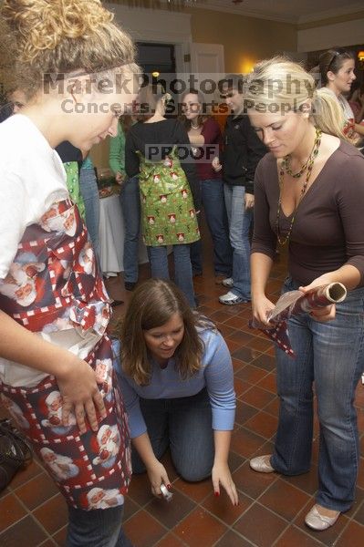 Meredith Clonch (blue) helps Lindsay Fraley dress Anna Matthews in wrapping paper at the Alpha Delta Pi Christmas party, Sunday, December 10, 2006.

Filename: SRM_20061210_1837440.jpg
Aperture: f/5.0
Shutter Speed: 1/100
Body: Canon EOS 20D
Lens: Canon EF-S 18-55mm f/3.5-5.6