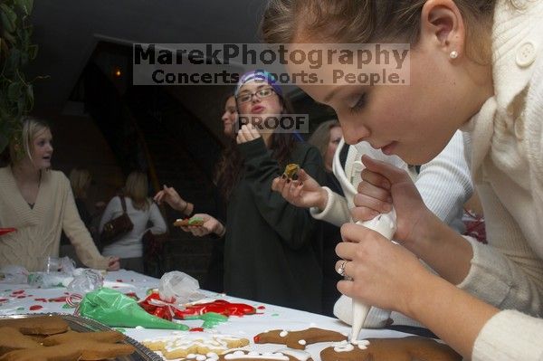 Lauren Fletcher puts frosting on a gingerbread man as Allison Grady, Jessica Hensarly, and Lauren Stewart (from right) eat theirs at the Alpha Delta Pi Christmas party, Sunday, December 10, 2006.

Filename: SRM_20061210_1906028.jpg
Aperture: f/7.1
Shutter Speed: 1/100
Body: Canon EOS 20D
Lens: Canon EF-S 18-55mm f/3.5-5.6