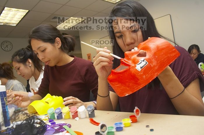 Emily Ng, right, decorates her mask next to Vivian Mai-Tran, left, at a domestic violence expressive arts workshop for survivors and friends of survivors of domestic and relationship violence.

Filename: SRM_20061023_1739208.jpg
Aperture: f/5.6
Shutter Speed: 1/100
Body: Canon EOS 20D
Lens: Canon EF-S 18-55mm f/3.5-5.6