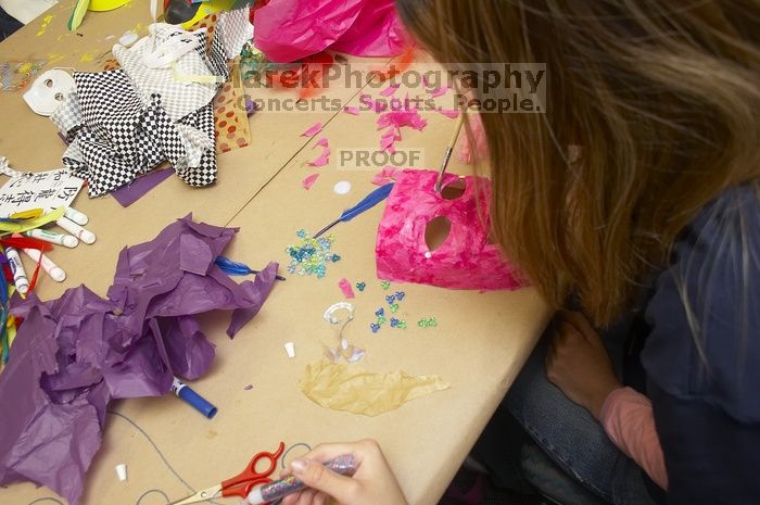 Sharon Kim decorates her mask at a domestic violence expressive arts workshop for survivors and friends of survivors of domestic and relationship violence.

Filename: SRM_20061023_1756409.jpg
Aperture: f/5.6
Shutter Speed: 1/100
Body: Canon EOS 20D
Lens: Canon EF-S 18-55mm f/3.5-5.6