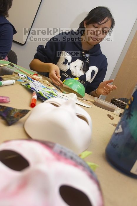 Stephanie Luu, with Hannah Jones' mask in the foreground.  Domestic violence expressive arts workshop for survivors and friends of survivors of domestic and relationship violence.

Filename: SRM_20061023_1800127.jpg
Aperture: f/5.6
Shutter Speed: 1/100
Body: Canon EOS 20D
Lens: Canon EF-S 18-55mm f/3.5-5.6