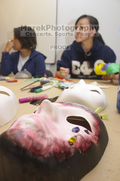 Stephanie Luu, with Hannah Jones' mask in the foreground.  Domestic violence expressive arts workshop for survivors and friends of survivors of domestic and relationship violence.

Filename: SRM_20061023_1801049.jpg
Aperture: f/5.6
Shutter Speed: 1/100
Body: Canon EOS 20D
Lens: Canon EF-S 18-55mm f/3.5-5.6