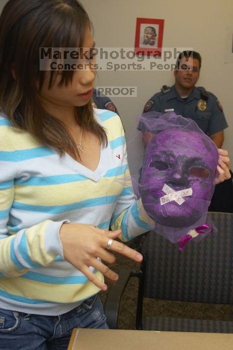 Mae Cortes describes her mask at a domestic violence expressive arts workshop for survivors and friends of survivors of domestic and relationship violence.

Filename: SRM_20061023_1824245.jpg
Aperture: f/5.6
Shutter Speed: 1/100
Body: Canon EOS 20D
Lens: Canon EF-S 18-55mm f/3.5-5.6