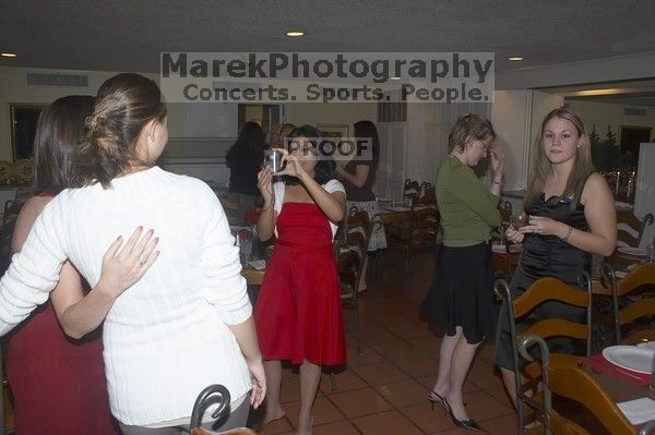 Alina Rizbia takes a photo of Madi Houston and unknown at the Alpha Xi Delta Christmas dinner, Friday, December 4, 2006.

Filename: SRM_20061204_1752564.jpg
Aperture: f/6.3
Shutter Speed: 1/250
Body: Canon EOS 20D
Lens: Canon EF-S 18-55mm f/3.5-5.6