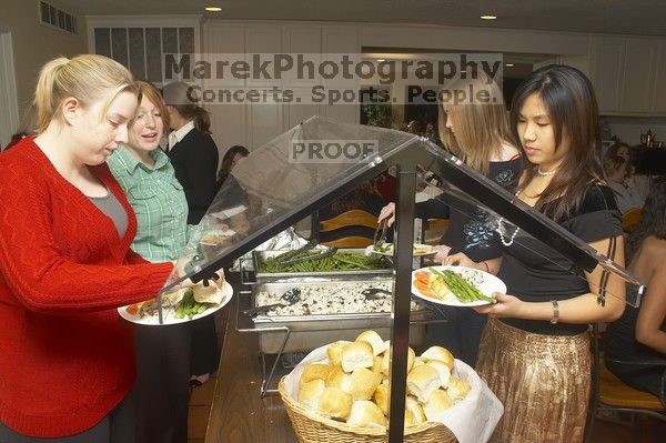 Veronica Hamlett, in green, and Joy Ching, on right, get food at the Alpha Xi Delta Christmas dinner, Friday, December 4, 2006.

Filename: SRM_20061204_1815000.jpg
Aperture: f/6.3
Shutter Speed: 1/250
Body: Canon EOS 20D
Lens: Canon EF-S 18-55mm f/3.5-5.6