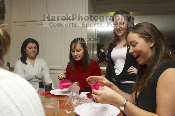 Mandy Mauldin, center, gives presents to Jessica Schreyer, left, and Allison Leah, right, at the Alpha Xi Delta Christmas dinner, Friday, December 4, 2006.

Filename: SRM_20061204_1815222.jpg
Aperture: f/6.3
Shutter Speed: 1/250
Body: Canon EOS 20D
Lens: Canon EF-S 18-55mm f/3.5-5.6