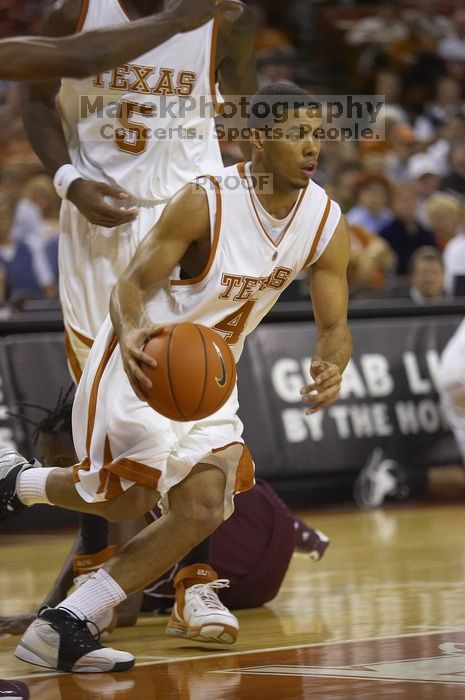 Guard D.J. Augustin, #14.  The longhorns defeated the Texas Southern University (TSU) Tigers 90-50 Tuesday night.

Filename: SRM_20061128_2013408.jpg
Aperture: f/2.8
Shutter Speed: 1/640
Body: Canon EOS-1D Mark II
Lens: Canon EF 80-200mm f/2.8 L