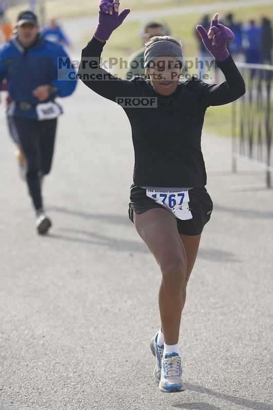 Venus Dever, 1:40:07, dancing across the finish at Decker Challenge 20K 2006 road race.

Filename: SRM_20061203_0944086.jpg
Aperture: f/4.0
Shutter Speed: 1/800
Body: Canon EOS-1D Mark II
Lens: Canon EF 80-200mm f/2.8 L