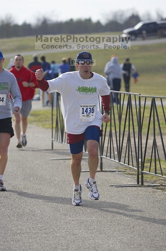 Brian Snider, 1:40:16, cheering himself across the finish at the Decker Challenge 20K 2006 road race.

Filename: SRM_20061203_0944185.jpg
Aperture: f/4.0
Shutter Speed: 1/1250
Body: Canon EOS-1D Mark II
Lens: Canon EF 80-200mm f/2.8 L