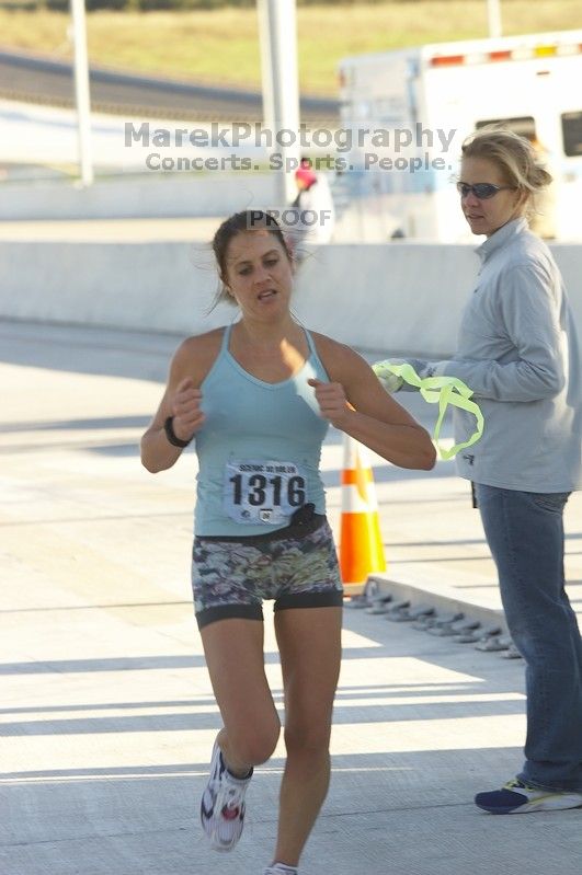 Sarah Shuler, bib #1316, places first for the women with a time of 1:02:45 at The Girl Scout Scenic 10 Miler road race, Sunday, October 22, 2006.

Filename: SRM_20061022_0857345.jpg
Aperture: f/6.3
Shutter Speed: 1/250
Body: Canon EOS 20D
Lens: Canon EF 80-200mm f/2.8 L