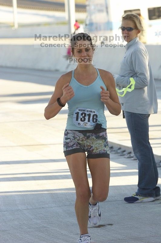 Sarah Shuler, bib #1316, places first for the women with a time of 1:02:45 at The Girl Scout Scenic 10 Miler road race, Sunday, October 22, 2006.

Filename: SRM_20061022_0857366.jpg
Aperture: f/6.3
Shutter Speed: 1/250
Body: Canon EOS 20D
Lens: Canon EF 80-200mm f/2.8 L