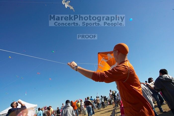 Chris Lam attempts to fly his UT kite at the 79th annual Zilker Park Kite Festival, Sunday, March 4, 2007.

Filename: SRM_20070304_1531540.jpg
Aperture: f/11.0
Shutter Speed: 1/250
Body: Canon EOS-1D Mark II
Lens: Sigma 15-30mm f/3.5-4.5 EX Aspherical DG DF