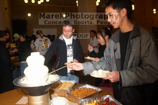 Andrew Wu, Mimi Nguyen, and Quan Ma.  The Asian Business Students Association (ABSA) hosted a chocolate fondue Friday, January 26, 2007 before heading off to a movie premier.

Filename: SRM_20070126_1632442.jpg
Aperture: f/5.6
Shutter Speed: 1/160
Body: Canon EOS 20D
Lens: Canon EF-S 18-55mm f/3.5-5.6