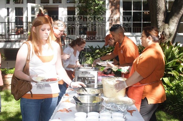 Lindsay Nichols and her parents grab some barbecue.  Kappa Kappa Gamma (KKG) hosted a parents' weekend barbecue before the UT vs Nebraska football game on Saturday, October 27, 2007 at their sorority house.

Filename: SRM_20071027_1204502.jpg
Aperture: f/8.0
Shutter Speed: 1/250
Body: Canon EOS 20D
Lens: Canon EF-S 18-55mm f/3.5-5.6