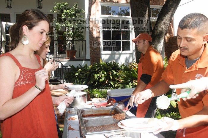 Sisters Allison and Mary Stewart Anderson, both Kappas, with their father.  Kappa Kappa Gamma (KKG) hosted a parents' weekend barbecue before the UT vs Nebraska football game on Saturday, October 27, 2007 at their sorority house.

Filename: SRM_20071027_1245444.jpg
Aperture: f/8.0
Shutter Speed: 1/250
Body: Canon EOS 20D
Lens: Canon EF-S 18-55mm f/3.5-5.6