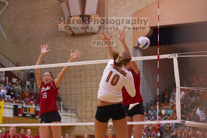 UT sophomore Ashley Engle (#10, S/RS) spikes on Nebraska sophomore Kori Cooper (#15, MB) and Nebraska senior Christina Houghtelling (#3, OH).  The Longhorns defeated the Huskers 3-0 on Wednesday night, October 24, 2007 at Gregory Gym.

Filename: SRM_20071024_1839225.jpg
Aperture: f/3.5
Shutter Speed: 1/400
Body: Canon EOS-1D Mark II
Lens: Canon EF 80-200mm f/2.8 L