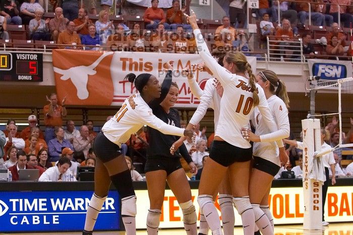 UT sophomore Ashley Engle (#10, S/RS), UT sophomore Destinee Hooker (#21, OH), UT senior Michelle Moriarty (#4, S), UT junior Lauren Paolini (#3, UTIL), and UT senior Alyson Jennings (#16, L) celebrate after a point.  The Longhorns defeated the Huskers 3-0

Filename: SRM_20071024_1842185.jpg
Aperture: f/4.0
Shutter Speed: 1/400
Body: Canon EOS-1D Mark II
Lens: Canon EF 80-200mm f/2.8 L