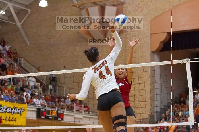 UT senior Brandy Magee (#44, MB) spikes the ball as a Nebraska player attempts to block it.  The Longhorns defeated the Huskers 3-0 on Wednesday night, October 24, 2007 at Gregory Gym.

Filename: SRM_20071024_1844382.jpg
Aperture: f/4.0
Shutter Speed: 1/400
Body: Canon EOS-1D Mark II
Lens: Canon EF 80-200mm f/2.8 L