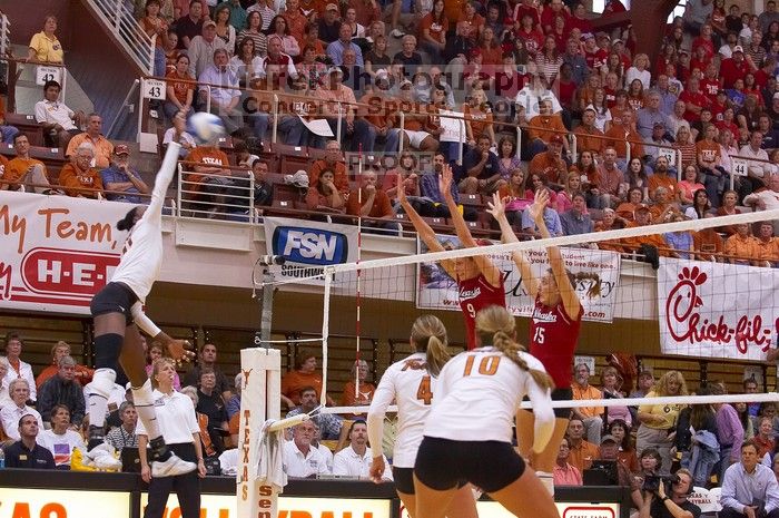 UT senior Brandy Magee (#44, MB) hits the ball towards blockers Nebraska sophomore Kori Cooper (#15, MB) and Nebraska senior Sarah Pavan (#9, RS) as UT senior Michelle Moriarty (#4, S) and UT sophomore Ashley Engle (#10, S/RS) watch.  The Longhorns defeate

Filename: SRM_20071024_1845281.jpg
Aperture: f/4.0
Shutter Speed: 1/400
Body: Canon EOS-1D Mark II
Lens: Canon EF 80-200mm f/2.8 L