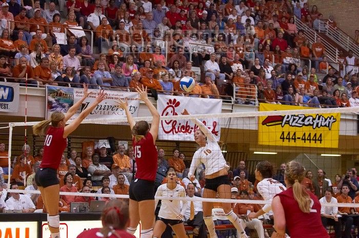 UT sophomore Ashley Engle (#10, S/RS) spikes the ball as Nebraska junior Jordan Larson (#10, OH) and Nebraska sophomore Kori Cooper (#15, MB) attempt to block it, and UT senior Michelle Moriarty (#4, S), UT junior Lauren Paolini (#3, UTIL) and Nebraska sop

Filename: SRM_20071024_1924469.jpg
Aperture: f/4.0
Shutter Speed: 1/400
Body: Canon EOS-1D Mark II
Lens: Canon EF 80-200mm f/2.8 L