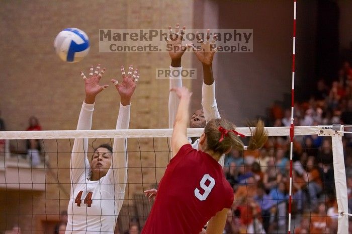 UT senior Brandy Magee (#44, MB) and UT sophomore Destinee Hooker (#21, OH) block a hit by Nebraska senior Sarah Pavan (#9, RS).  The Longhorns defeated the Huskers 3-0 on Wednesday night, October 24, 2007 at Gregory Gym.

Filename: SRM_20071024_1928524.jpg
Aperture: f/4.0
Shutter Speed: 1/400
Body: Canon EOS-1D Mark II
Lens: Canon EF 80-200mm f/2.8 L