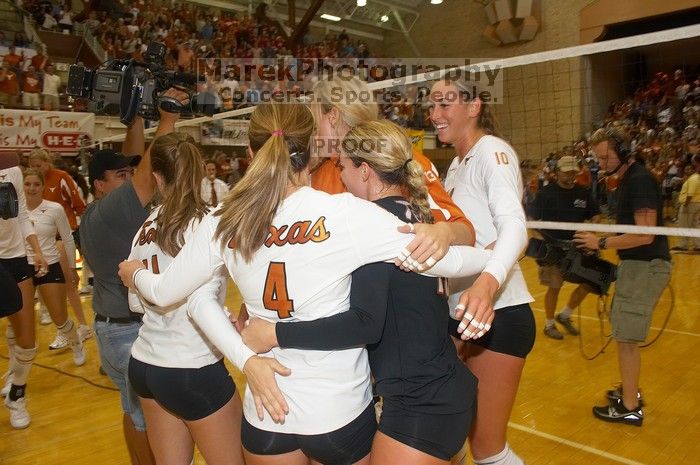 UT senior Alyson Jennings (#16, L) hugs UT senior Michelle Moriarty (#4, S) and UT junior Kiley Hall (#11, DS/L) to celebrate their win over Nebraska.  The Longhorns defeated the Huskers 3-0 on Wednesday night, October 24, 2007 at Gregory Gym.

Filename: SRM_20071024_2016387.jpg
Aperture: f/5.6
Shutter Speed: 1/100
Body: Canon EOS 20D
Lens: Canon EF-S 18-55mm f/3.5-5.6