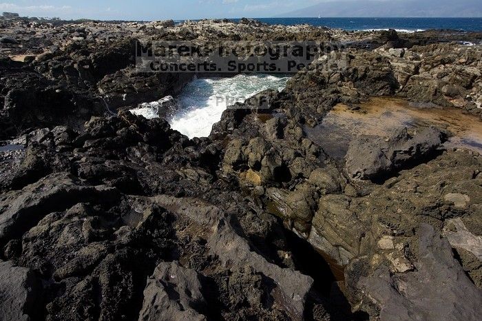 Hike to the Nakalele blowholes along the surf-beaten lava formations.

Filename: SRM_20071219_1229470.jpg
Aperture: f/8.0
Shutter Speed: 1/2500
Body: Canon EOS-1D Mark II
Lens: Sigma 15-30mm f/3.5-4.5 EX Aspherical DG DF