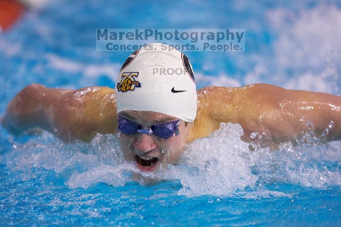 Georgia's Gil Stovall took first in the 200 yard butterfly with a time of 1:47.32.  The University of Texas Longhorns defeated The University of Georgia Bulldogs 157-135 on Saturday, January 12, 2008.

Filename: SRM_20080112_1127246.jpg
Aperture: f/2.8
Shutter Speed: 1/400
Body: Canon EOS-1D Mark II
Lens: Canon EF 300mm f/2.8 L IS