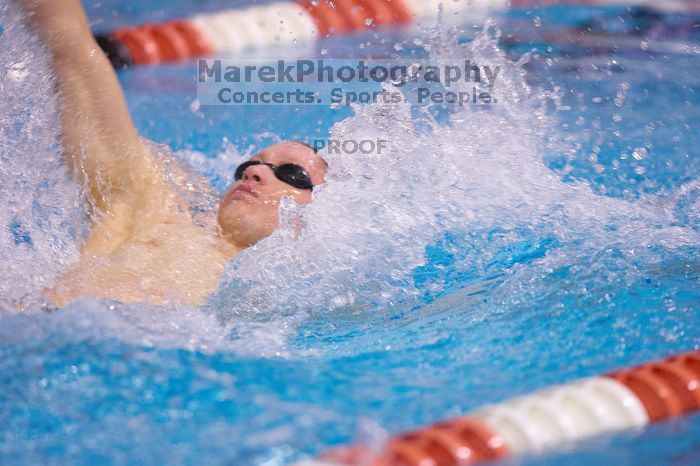 UT senior Matthew McGinnis took first in the 200 yard backstroke with a time of 1:47.37.  The University of Texas Longhorns defeated The University of Georgia Bulldogs 157-135 on Saturday, January 12, 2008.

Filename: SRM_20080112_1158344.jpg
Aperture: f/2.8
Shutter Speed: 1/400
Body: Canon EOS-1D Mark II
Lens: Canon EF 300mm f/2.8 L IS