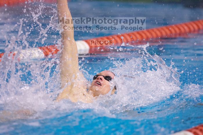 UT senior Matthew McGinnis took first in the 200 yard backstroke with a time of 1:47.37.  The University of Texas Longhorns defeated The University of Georgia Bulldogs 157-135 on Saturday, January 12, 2008.

Filename: SRM_20080112_1158386.jpg
Aperture: f/2.8
Shutter Speed: 1/400
Body: Canon EOS-1D Mark II
Lens: Canon EF 300mm f/2.8 L IS