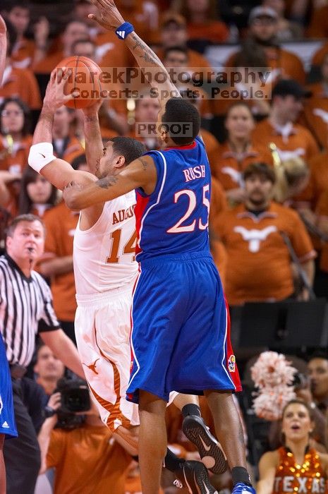 UT sophomore D.J. Augustin (#14, G) attempts a shot as KU junior Brandon Rush (#25, Guard) tries to block.  The University of Texas (UT) Longhorns defeated the University of Kansas Jayhawks 72-69 in Austin, Texas on Monday, February 11, 2008.

Filename: SRM_20080211_2032149.jpg
Aperture: f/2.8
Shutter Speed: 1/640
Body: Canon EOS 20D
Lens: Canon EF 300mm f/2.8 L IS