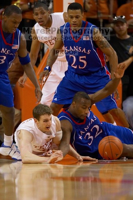 UT junior Connor Atchley (#32, F/C) and KU senior Darnell Jackson (#32, Forward) scramble for the ball.  The University of Texas (UT) Longhorns defeated the University of Kansas Jayhawks 72-69 in Austin, Texas on Monday, February 11, 2008.

Filename: SRM_20080211_2032327.jpg
Aperture: f/2.8
Shutter Speed: 1/640
Body: Canon EOS 20D
Lens: Canon EF 300mm f/2.8 L IS