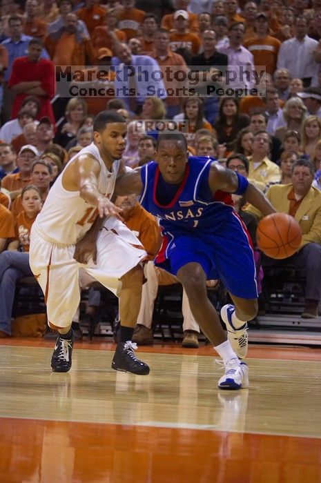 UT sophomore D.J. Augustin (#14, G) defends KU senior Russell Robinson (#3, Guard).  The University of Texas (UT) Longhorns defeated the University of Kansas Jayhawks 72-69 in Austin, Texas on Monday, February 11, 2008.

Filename: SRM_20080211_2040465.jpg
Aperture: f/2.8
Shutter Speed: 1/640
Body: Canon EOS-1D Mark II
Lens: Canon EF 80-200mm f/2.8 L