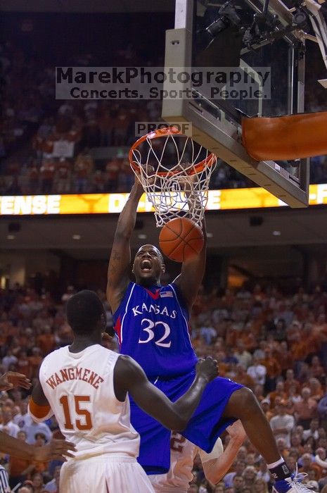 KU senior Darnell Jackson (#32, Forward) dunks over UT freshman Alexis Wangmene (#15, F/C) and UT junior Connor Atchley (#32, F/C).  The University of Texas (UT) Longhorns defeated the University of Kansas Jayhawks 72-69 in Austin, Texas on Monday, February 11, 2008.

Filename: SRM_20080211_2046080.jpg
Aperture: f/2.8
Shutter Speed: 1/640
Body: Canon EOS-1D Mark II
Lens: Canon EF 80-200mm f/2.8 L