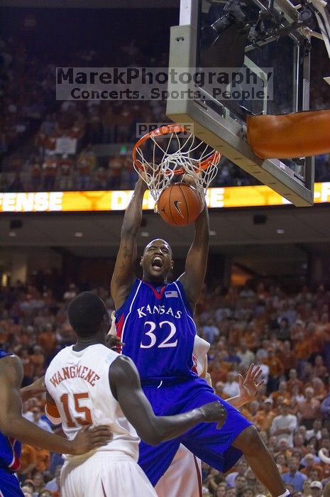 KU senior Darnell Jackson (#32, Forward) dunks over UT freshman Alexis Wangmene (#15, F/C) and UT junior Connor Atchley (#32, F/C).  The University of Texas (UT) Longhorns defeated the University of Kansas Jayhawks 72-69 in Austin, Texas on Monday, February 11, 2008.

Filename: SRM_20080211_2046089.jpg
Aperture: f/2.8
Shutter Speed: 1/640
Body: Canon EOS-1D Mark II
Lens: Canon EF 80-200mm f/2.8 L