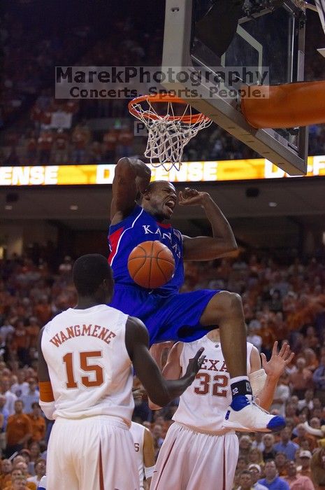 KU senior Darnell Jackson (#32, Forward) dunks over UT freshman Alexis Wangmene (#15, F/C) and UT junior Connor Atchley (#32, F/C).  The University of Texas (UT) Longhorns defeated the University of Kansas Jayhawks 72-69 in Austin, Texas on Monday, February 11, 2008.

Filename: SRM_20080211_2046122.jpg
Aperture: f/2.8
Shutter Speed: 1/640
Body: Canon EOS-1D Mark II
Lens: Canon EF 80-200mm f/2.8 L