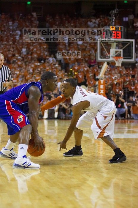 UT junior A.J. Abrams (#3, G) playing defense against a Kansas player.  The University of Texas (UT) Longhorns defeated the University of Kansas Jayhawks 72-69 in Austin, Texas on Monday, February 11, 2008.

Filename: SRM_20080211_2056487.jpg
Aperture: f/2.8
Shutter Speed: 1/640
Body: Canon EOS-1D Mark II
Lens: Canon EF 80-200mm f/2.8 L