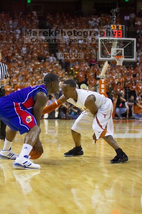 UT junior A.J. Abrams (#3, G) playing defense against a Kansas player.  The University of Texas (UT) Longhorns defeated the University of Kansas Jayhawks 72-69 in Austin, Texas on Monday, February 11, 2008.

Filename: SRM_20080211_2056488.jpg
Aperture: f/2.8
Shutter Speed: 1/640
Body: Canon EOS-1D Mark II
Lens: Canon EF 80-200mm f/2.8 L