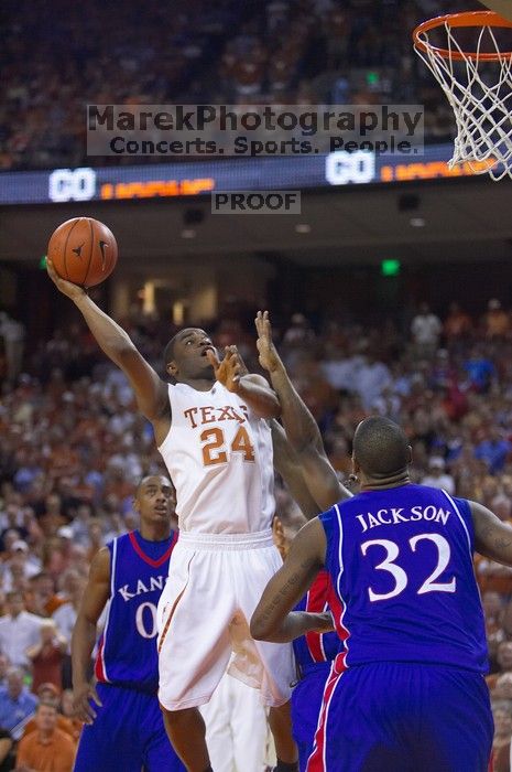 UT sophomore Justin Mason (#24, G) takes a shot over KU sophomore Darrell Arthur (#00, Forward) and KU senior Darnell Jackson (#32, Forward).  The University of Texas (UT) Longhorns defeated the University of Kansas Jayhawks 72-69 in Austin, Texas on Monday, February 11, 2008.

Filename: SRM_20080211_2118201.jpg
Aperture: f/2.8
Shutter Speed: 1/640
Body: Canon EOS-1D Mark II
Lens: Canon EF 80-200mm f/2.8 L