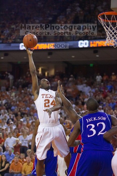 UT sophomore Justin Mason (#24, G) takes a shot over KU sophomore Darrell Arthur (#00, Forward) and KU senior Darnell Jackson (#32, Forward).  The University of Texas (UT) Longhorns defeated the University of Kansas Jayhawks 72-69 in Austin, Texas on Monday, February 11, 2008.

Filename: SRM_20080211_2118222.jpg
Aperture: f/2.8
Shutter Speed: 1/640
Body: Canon EOS-1D Mark II
Lens: Canon EF 80-200mm f/2.8 L