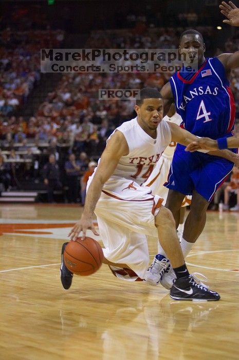 UT sophomore D.J. Augustin (#14, G) makes a drive past KU sophomore Sherron Collins (#4, Guard).  The University of Texas (UT) Longhorns defeated the University of Kansas Jayhawks 72-69 in Austin, Texas on Monday, February 11, 2008.

Filename: SRM_20080211_2142263.jpg
Aperture: f/2.8
Shutter Speed: 1/640
Body: Canon EOS-1D Mark II
Lens: Canon EF 80-200mm f/2.8 L