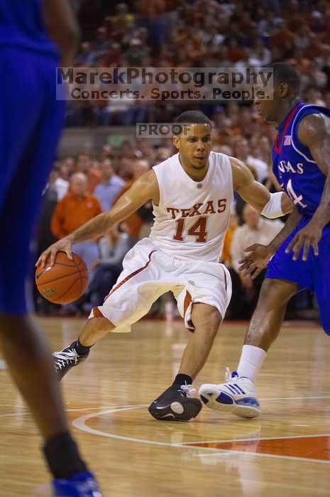 UT sophomore D.J. Augustin (#14, G) makes a drive past KU sophomore Sherron Collins (#4, Guard).  The University of Texas (UT) Longhorns defeated the University of Kansas Jayhawks 72-69 in Austin, Texas on Monday, February 11, 2008.

Filename: SRM_20080211_2145261.jpg
Aperture: f/2.8
Shutter Speed: 1/640
Body: Canon EOS-1D Mark II
Lens: Canon EF 80-200mm f/2.8 L