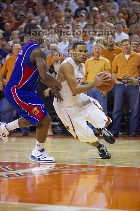 UT junior A.J. Abrams (#3, G) playing defense against a Kansas player.  The University of Texas (UT) Longhorns defeated the University of Kansas Jayhawks 72-69 in Austin, Texas on Monday, February 11, 2008.

Filename: SRM_20080211_2155367.jpg
Aperture: f/2.8
Shutter Speed: 1/640
Body: Canon EOS-1D Mark II
Lens: Canon EF 80-200mm f/2.8 L