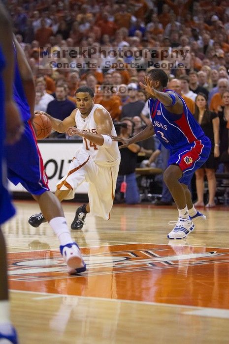 UT junior A.J. Abrams (#3, G) playing defense against a Kansas player.  The University of Texas (UT) Longhorns defeated the University of Kansas Jayhawks 72-69 in Austin, Texas on Monday, February 11, 2008.

Filename: SRM_20080211_2158140.jpg
Aperture: f/2.8
Shutter Speed: 1/640
Body: Canon EOS-1D Mark II
Lens: Canon EF 80-200mm f/2.8 L